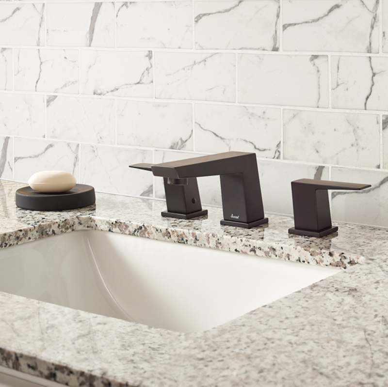 cream colored marble look glass tile backsplash bathroom