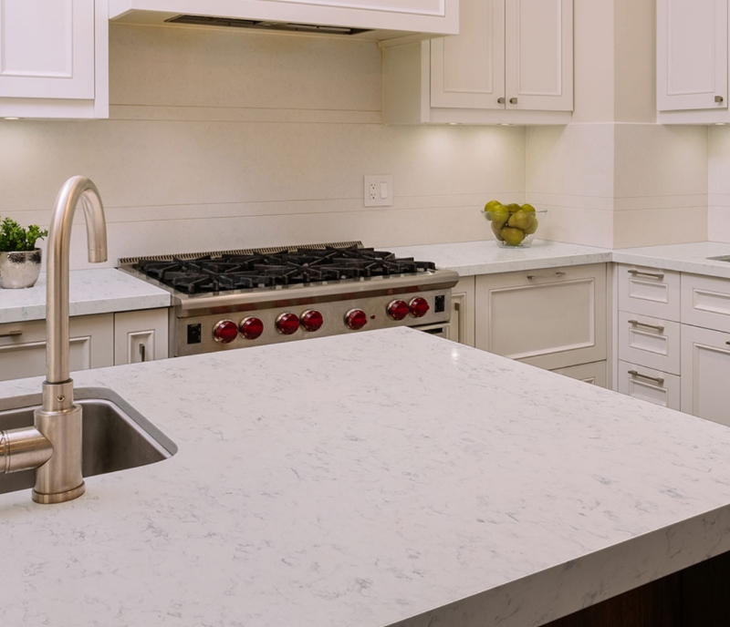 feathered veining marble look quartz in all white kitchen