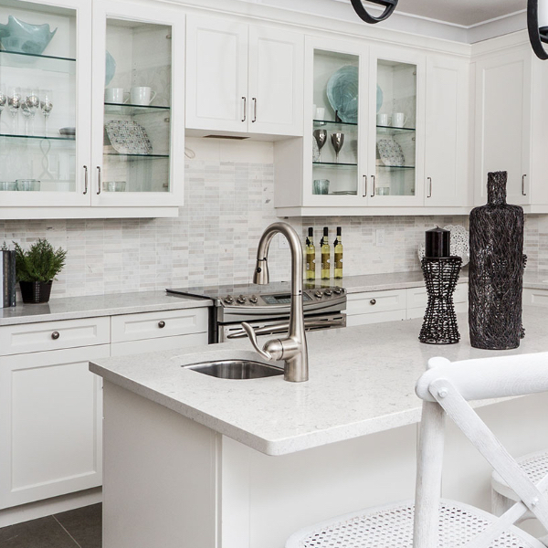 brilliant white marble look quartz in kitchen with glass door cabinets