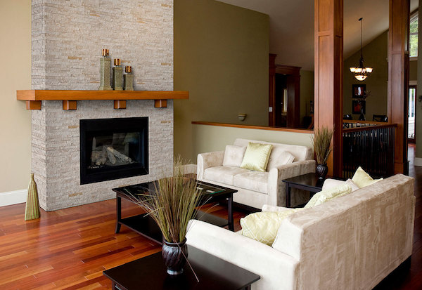 stacked stone panel fireplace with wood floors