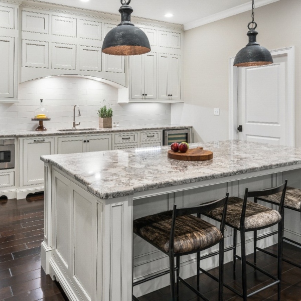 all white kitchen with cream variation granite