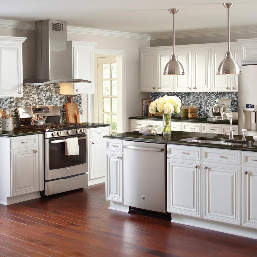 Black kitchen cabinets, granite top, and silver metallic back splash.  Gorgeous new kitchen. Silver round tile…