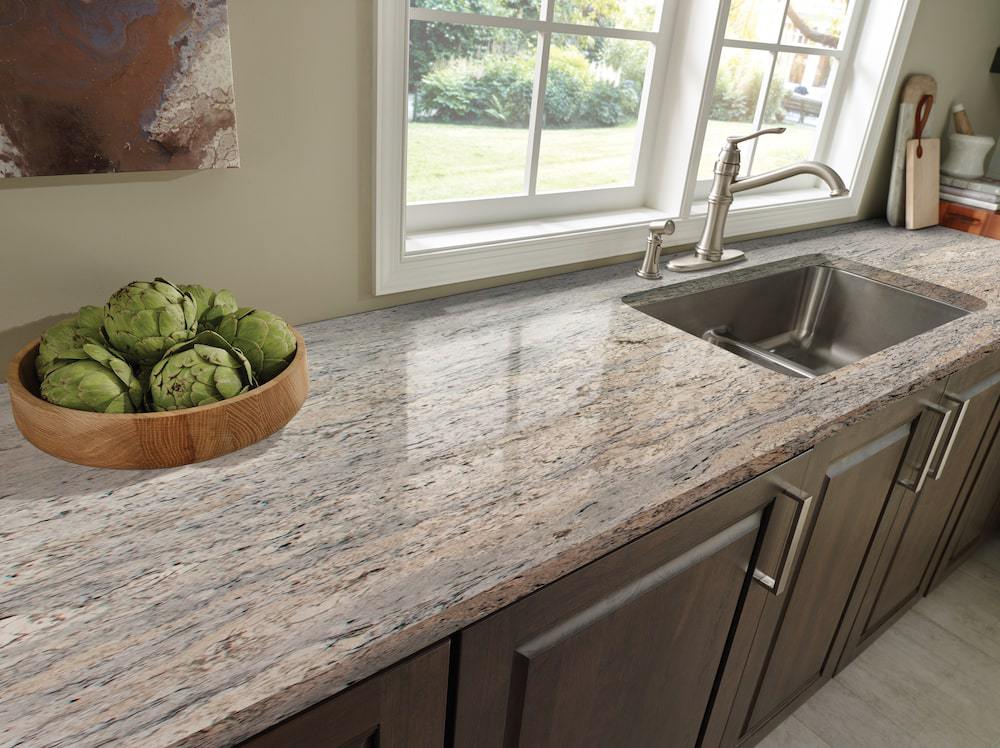 https://cdn.msisurfaces.com/images/blogs/posts/2023/01/msi-white-ice-speckled-granite-with-dark-wood-cabinets-july-2021-min.jpg