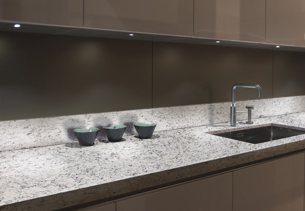 https://cdn.msisurfaces.com/images/blogs/posts/2023/05/msi-s-f-real-granite-kitchen-counter-with-cafe-cabinets-min.jpg