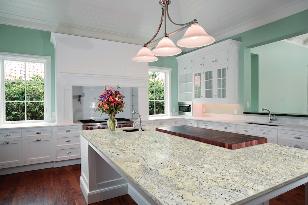 https://cdn.msisurfaces.com/images/blogs/posts/2023/05/msi-white-ice-granite-with-white-cabinets-min.jpg