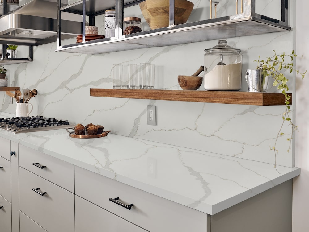 https://cdn.msisurfaces.com/images/blogs/posts/2023/06/msi-calacatta-idillio-quartz-countertop-and-kitchen-backsplash-with-light-grey-veining-min.jpg