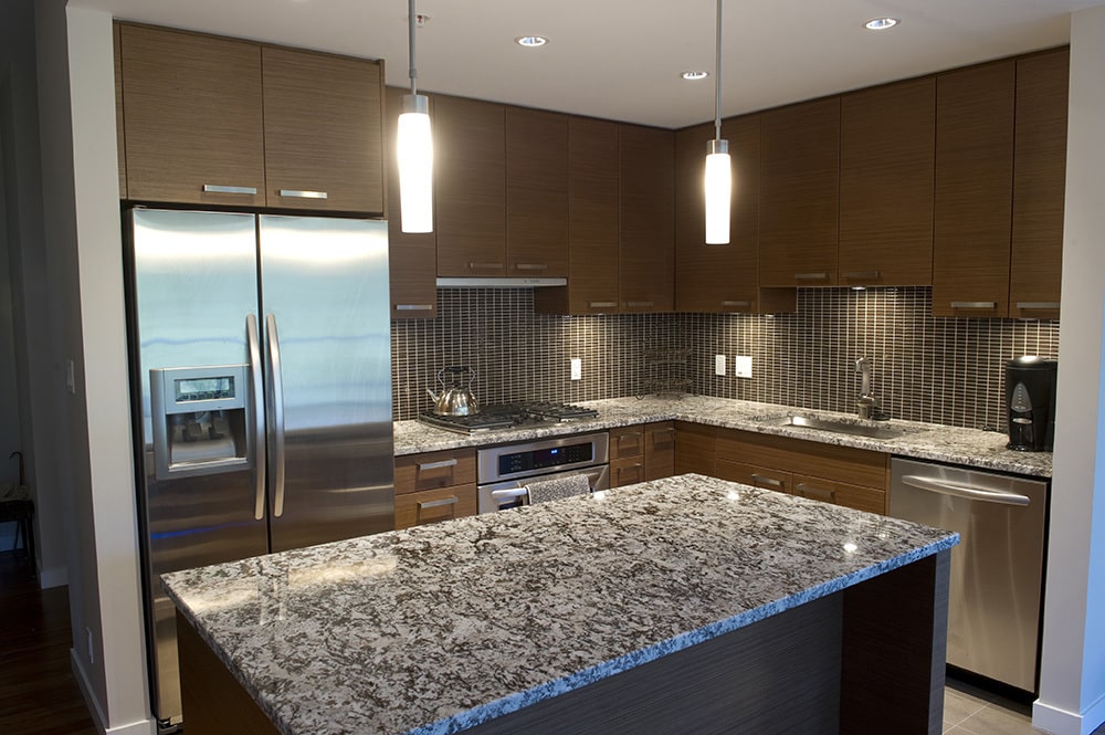 https://cdn.msisurfaces.com/images/blogs/posts/2023/08/msi-delicatus-white-granite-kitchen-island-min.jpg