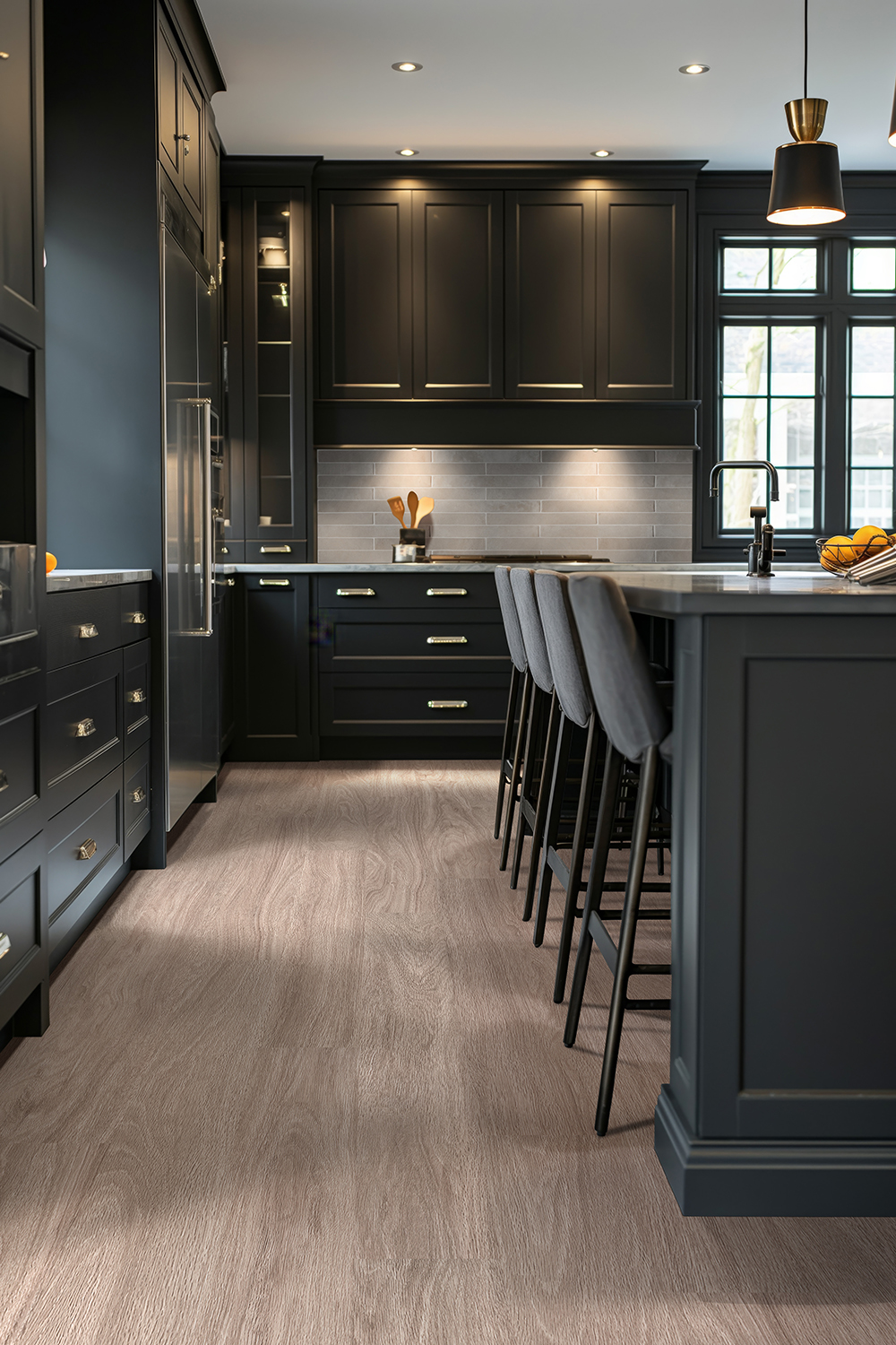Dark contemporary kitchen with wood-look vinyl plank flooring, illustrating glue down vs floating vinyl plank flooring options.