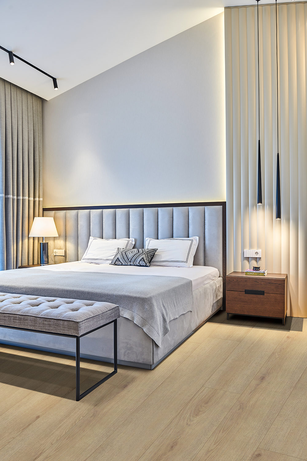Contemporary bedroom featuring light wood appearance LVT flooring, showcasing the comfort and longevity of the ideal LVT flooring thickness.