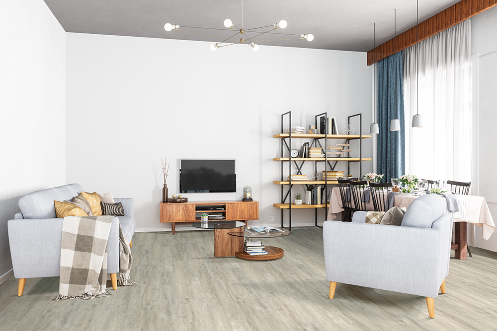 Modern living room with gray wood-look floating vinyl plank flooring, ideal for comparing glue down vs floating vinyl plank flooring.