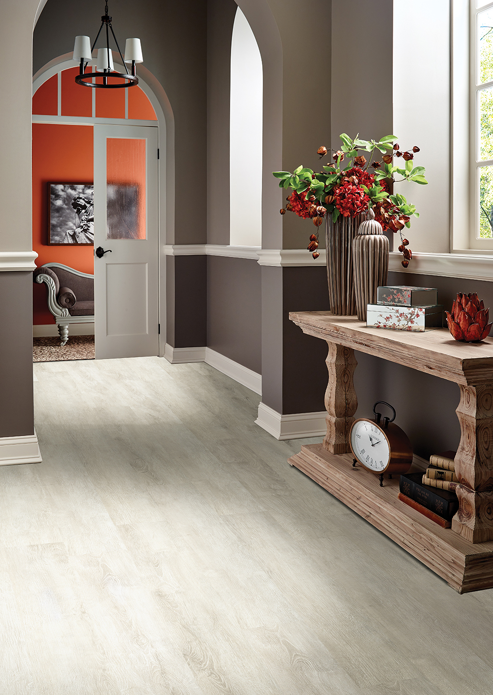 Bright entryway with light gray wood-look vinyl plank flooring, demonstrating a floating vinyl plank flooring installation.