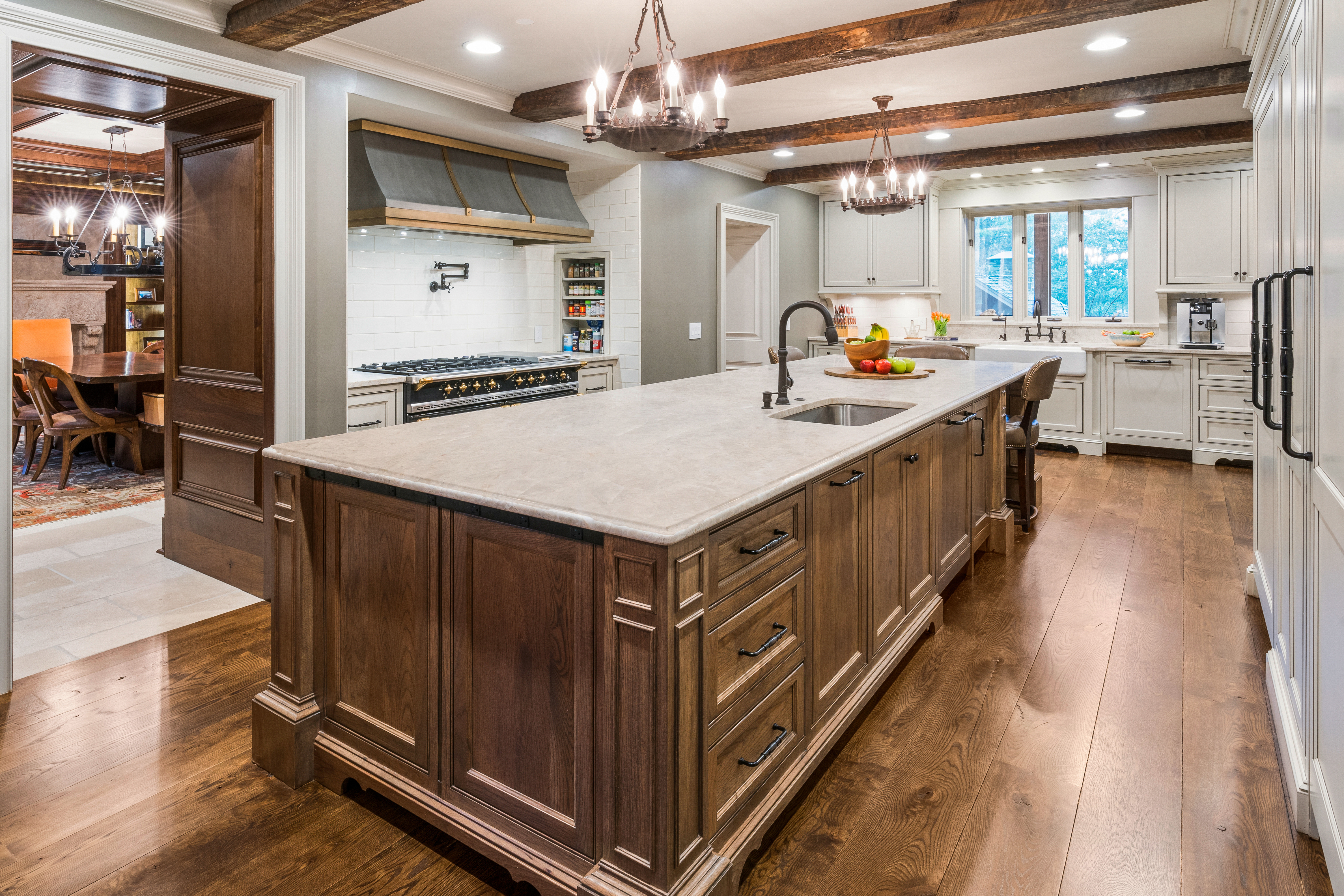 Traditional kitchen with a light quartzite countertop island, showing how to clean quartzite countertops to preserve their natural beauty.