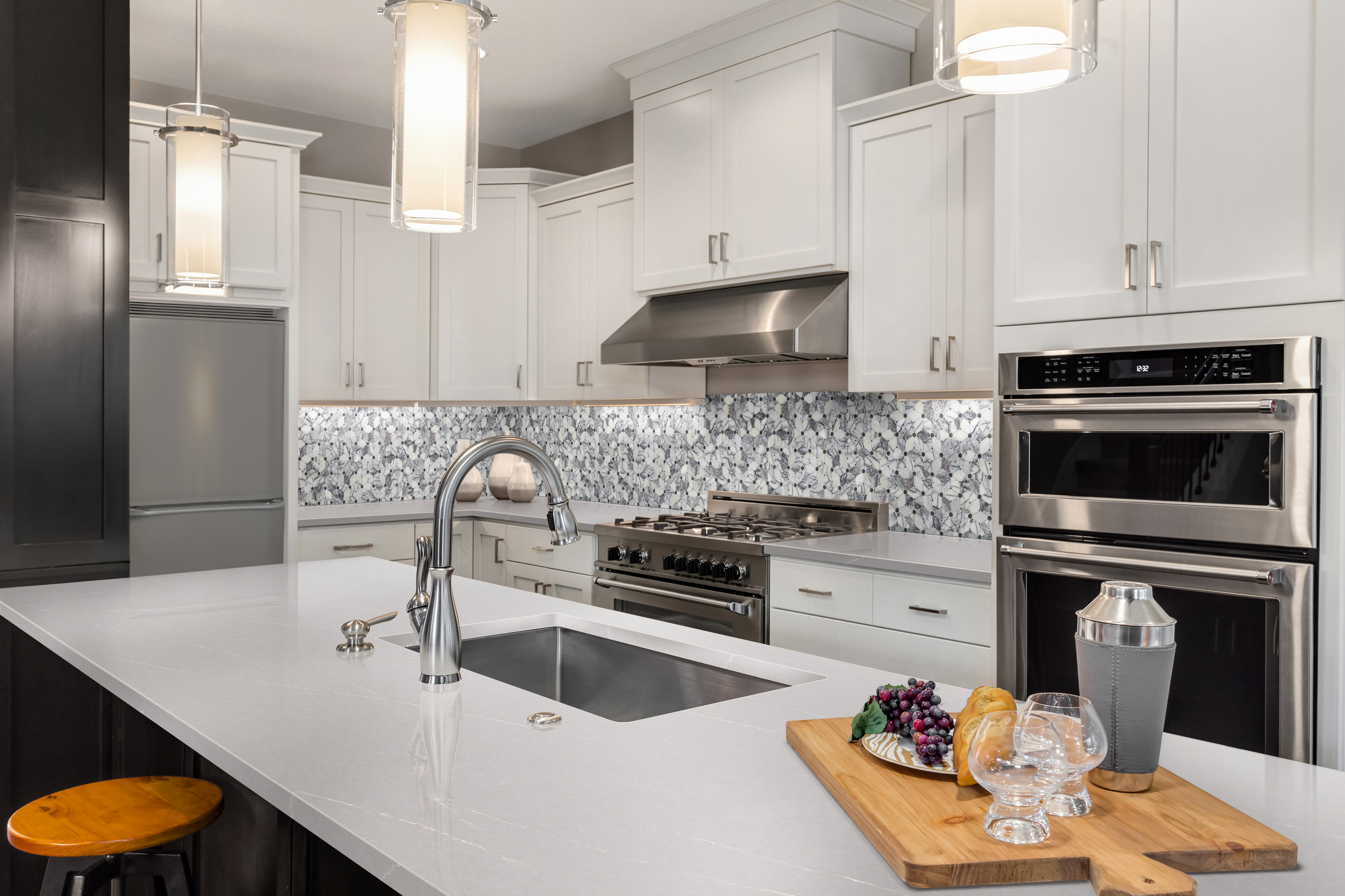 Spotless white quartz countertop in a modern kitchen after cleaning, showcasing the results of how to remove stains from quartz countertops effectively.
