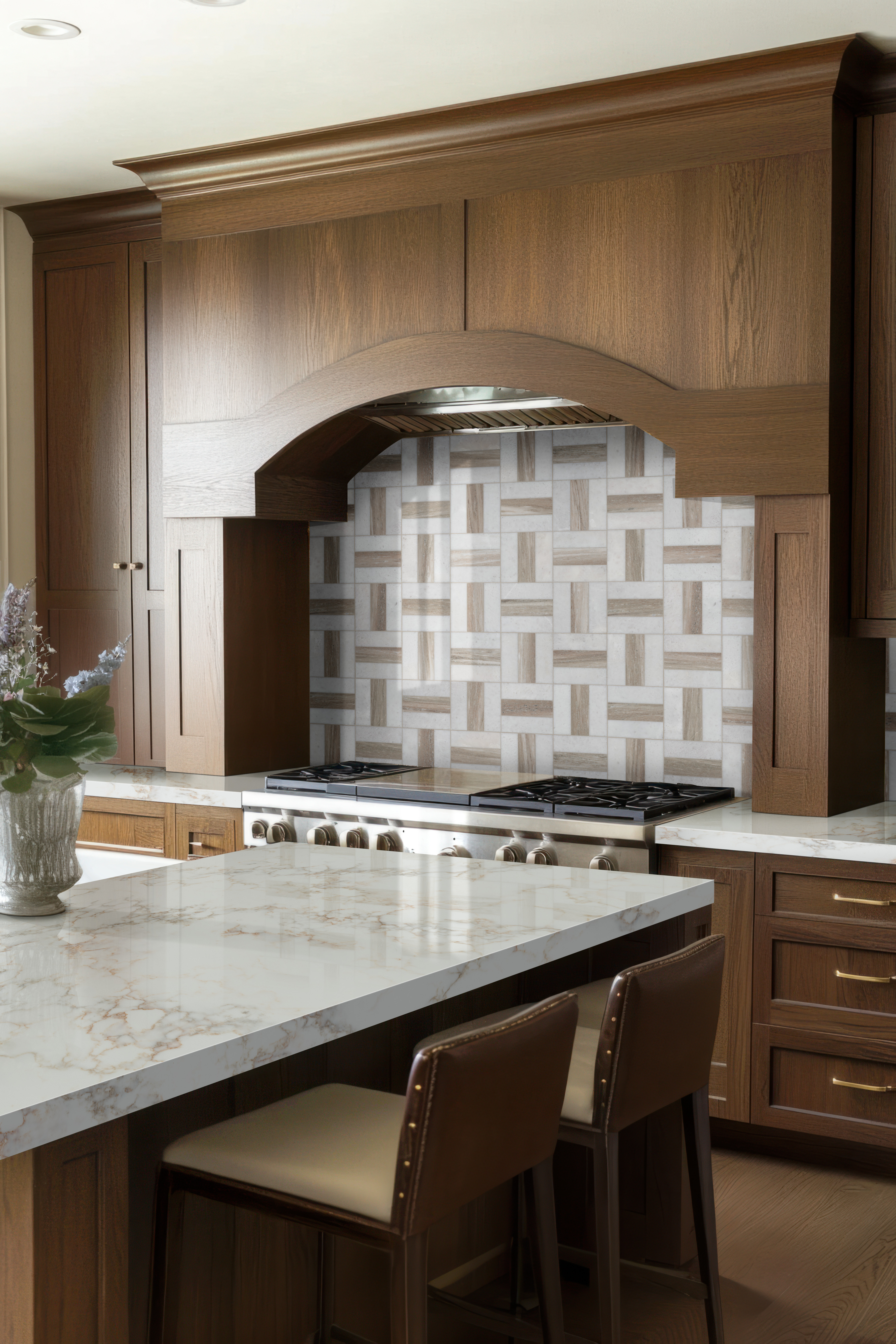 Marble-inspired quartz countertop and island with consistent veining, one of the pros and cons of quartz countertops.