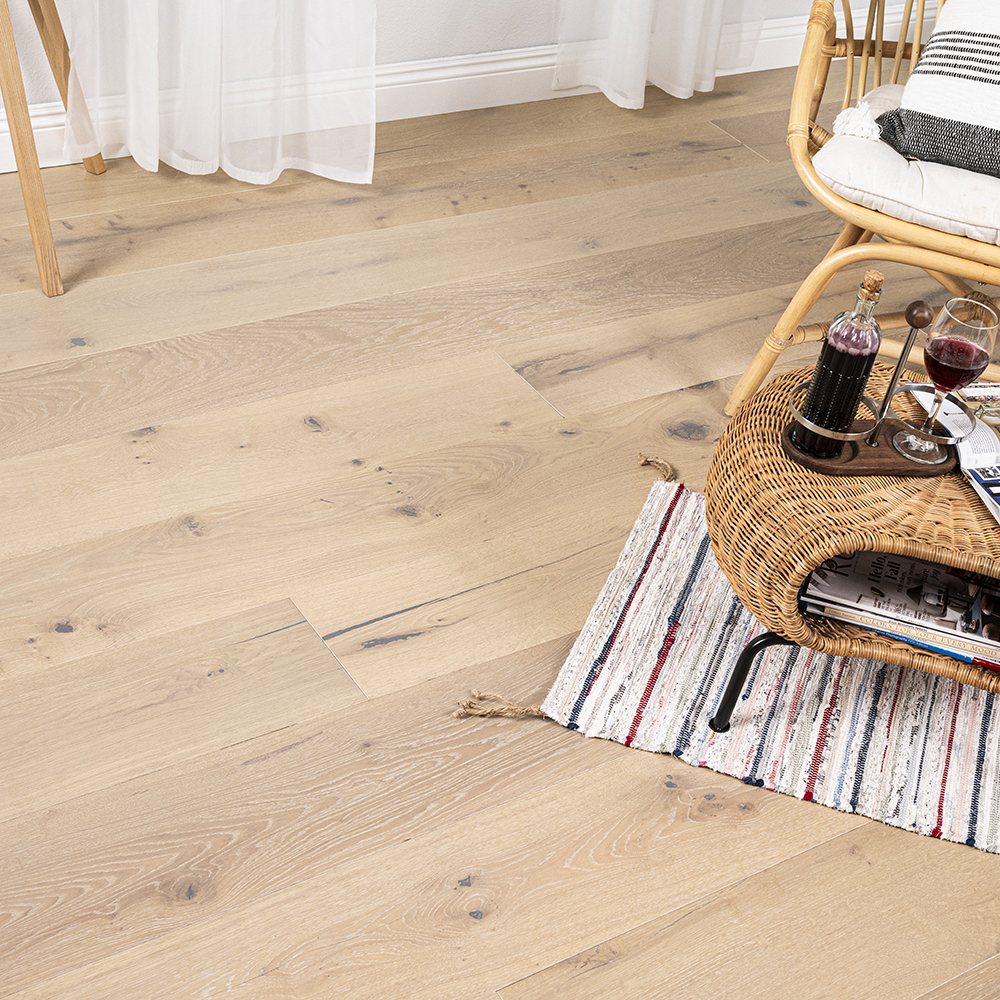 Close up of wide plank engineered hardwood flooring with natural wood grain, showing how engineered vs solid hardwood performs.