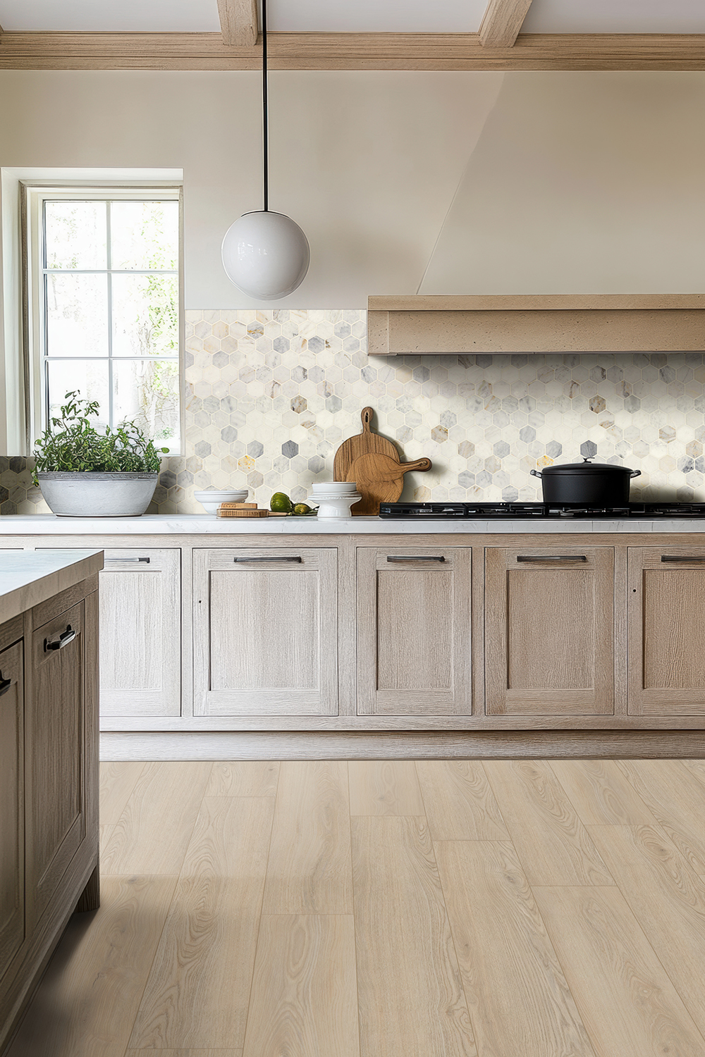 Modern kitchen with light oak-look vinyl plank flooring, highlighting flooring styles used in glue down vs floating vinyl plank flooring installations.