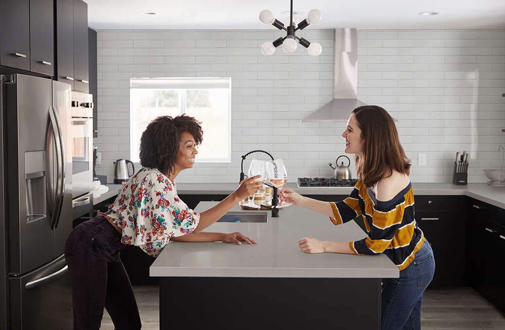 Contemporary kitchen featuring a white quartz island that emphasizes quartz countertop thickness for durability in daily use.