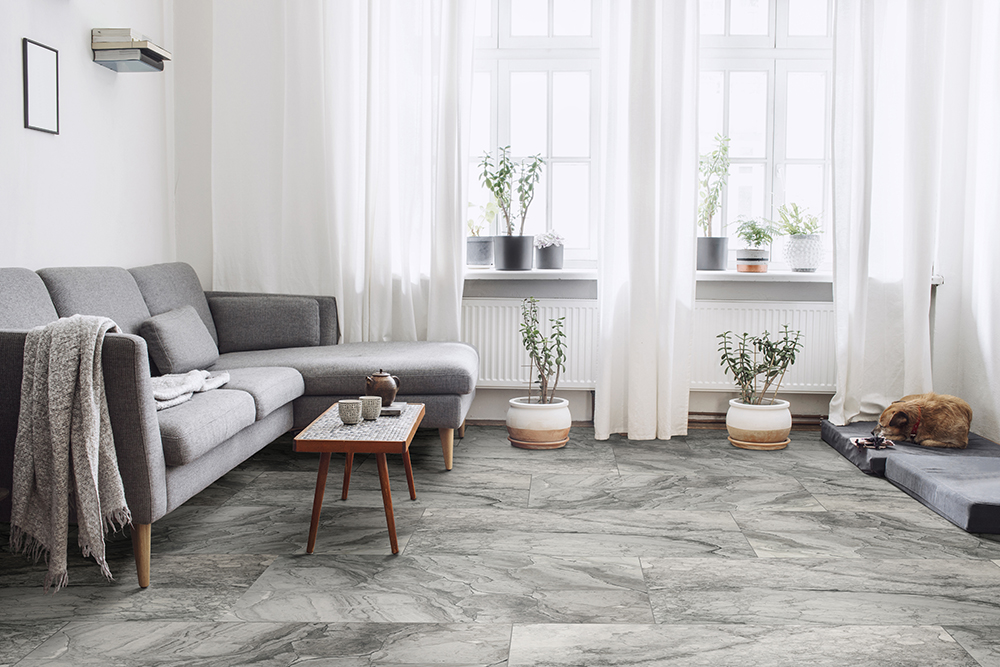 Gray large format porcelain tile flooring creates a seamless effect for high-traffic domestic living rooms.