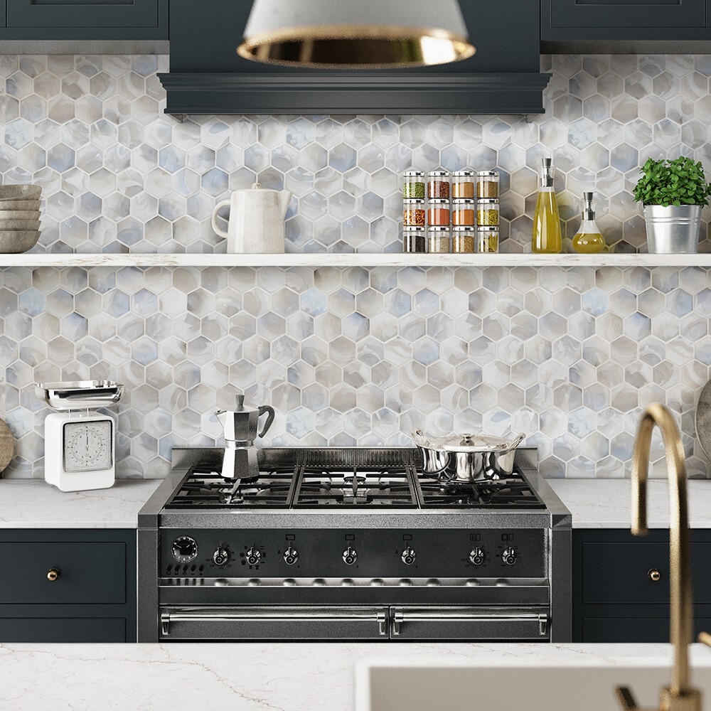 White and gray hexagon mosaic tile backsplash behind a range, highlighting a durable and decorative kitchen backsplash option.
