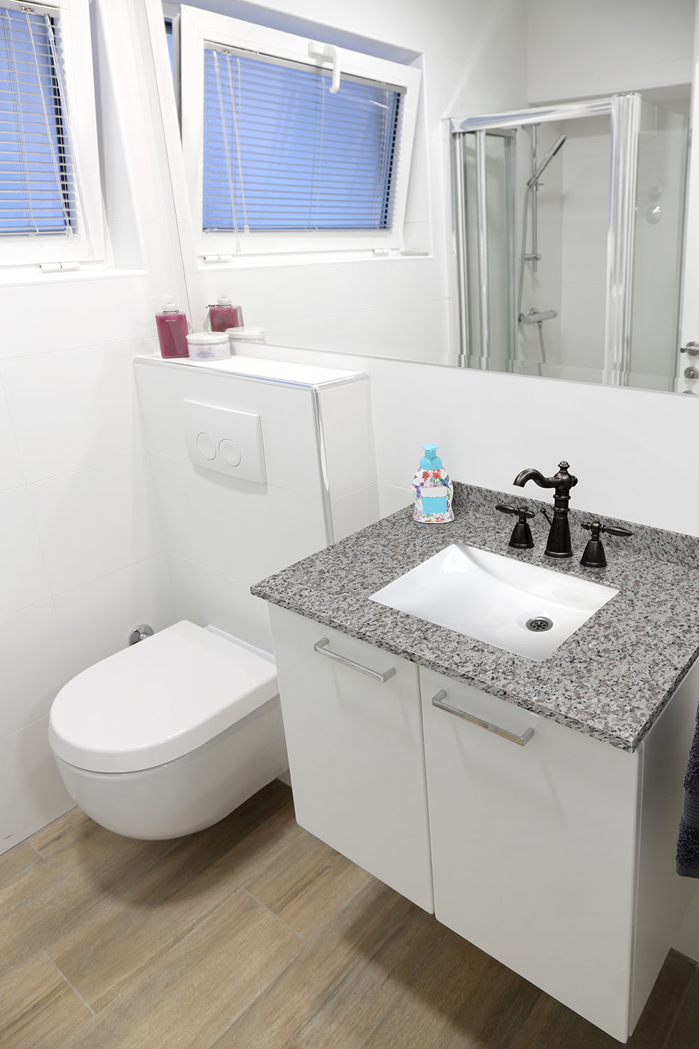Compact bathroom vanity with a granite countertop, displaying normal granite countertop thickness for household bathrooms.