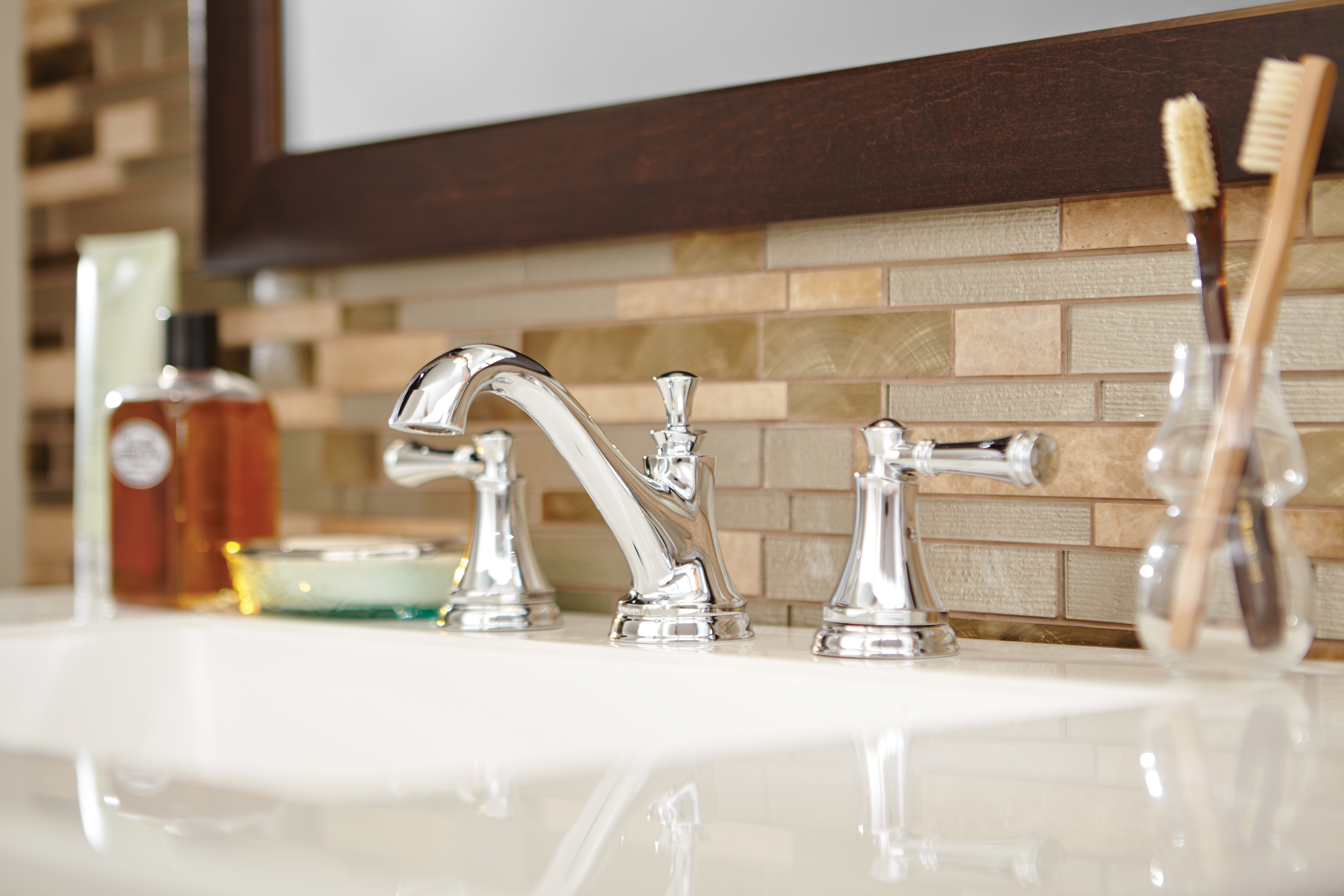 Bathroom sink with a glass subway mosaic tile backsplash, showing what is mosaic tile in a vanity application.