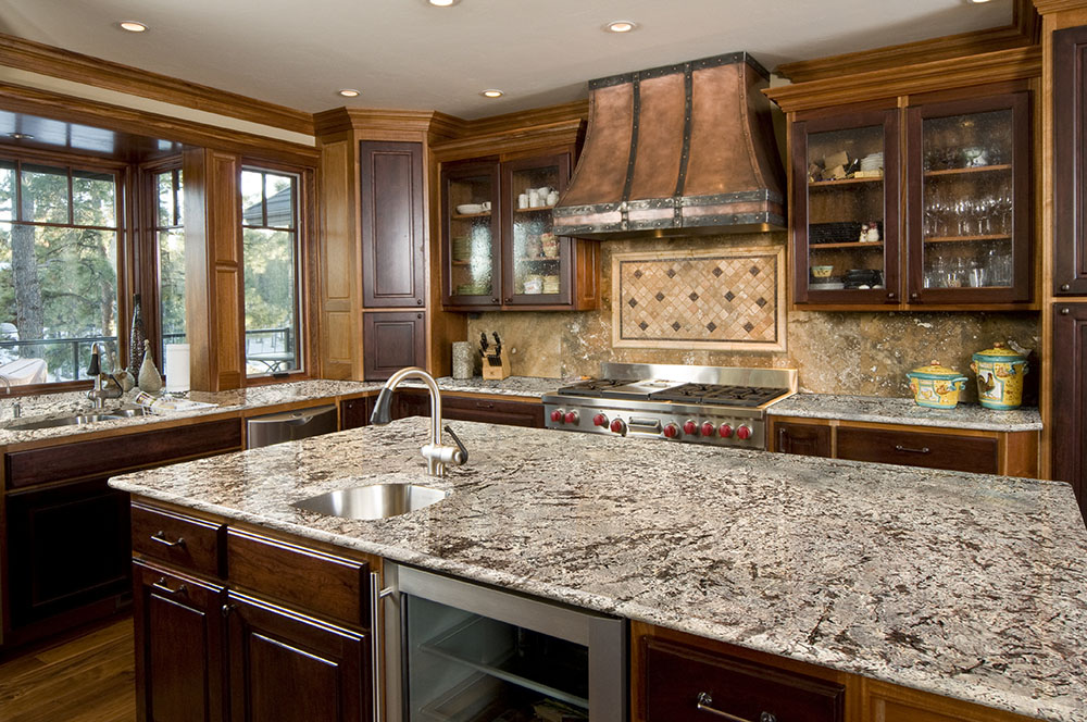 Modern kitchen with granite island, showing granite countertop thickness for huge work areas.