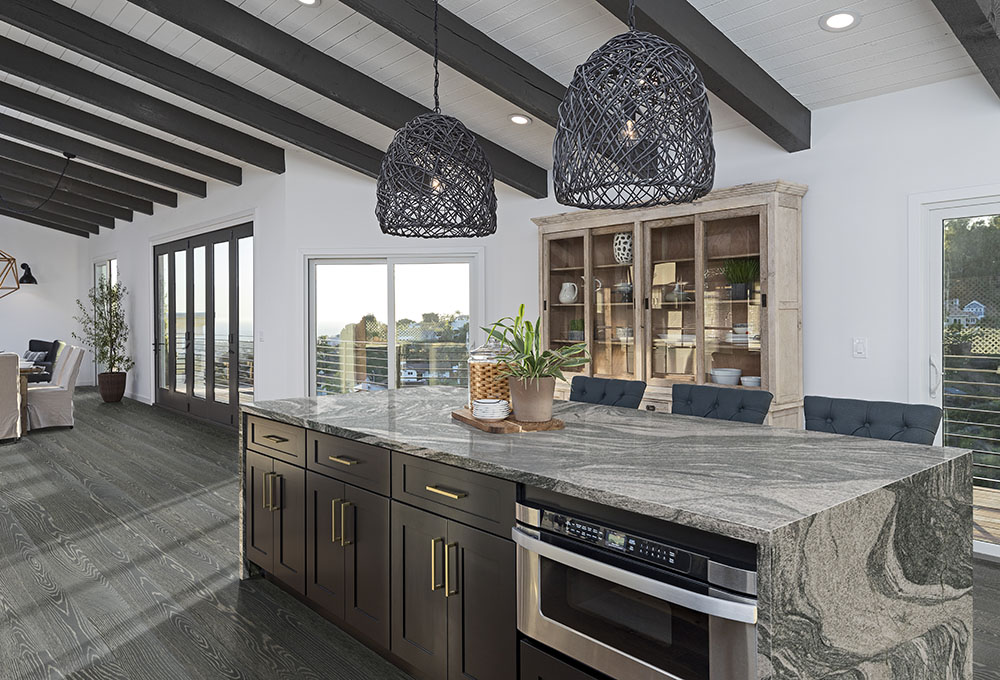 Contemporary kitchen with granite waterfall island, illustrating the granite countertop thickness in a modern style.