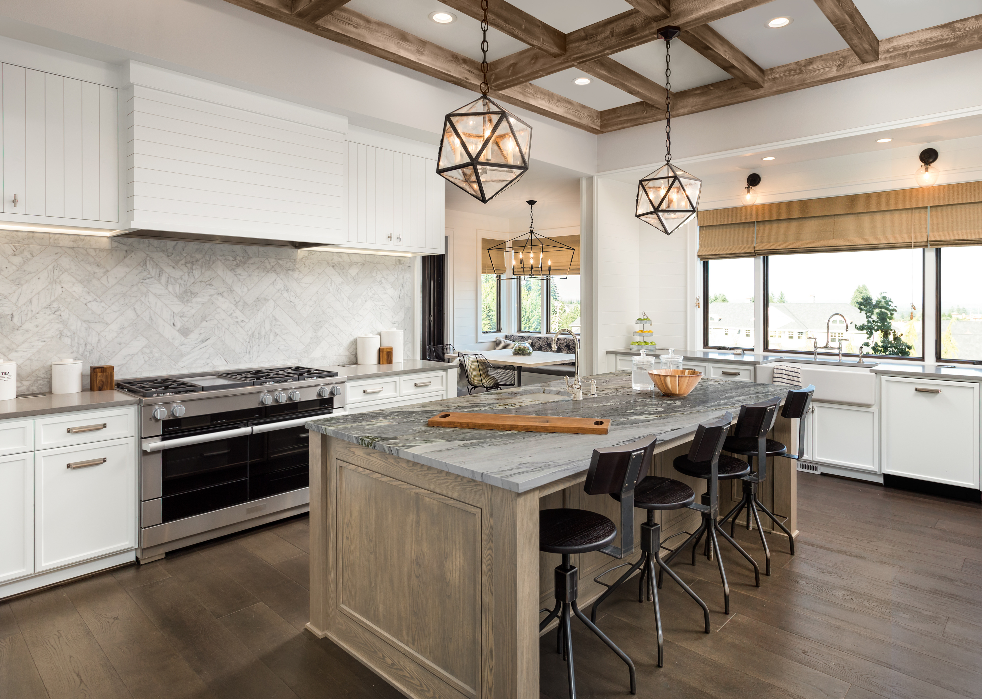 Modern kitchen with Calacatta Montreal Quartzite countertops, illustrating quartzite in a marble vs quartzite vs granite comparison.