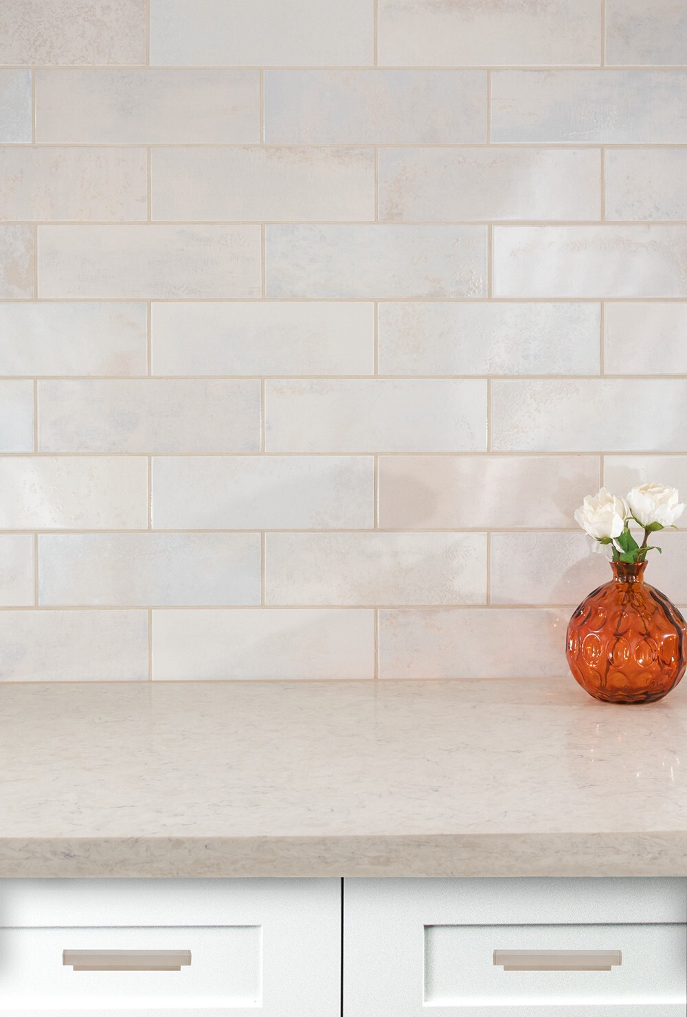 Neutral subway tile backsplash above a light countertop, showcasing a versatile tile option for everyday kitchen use.