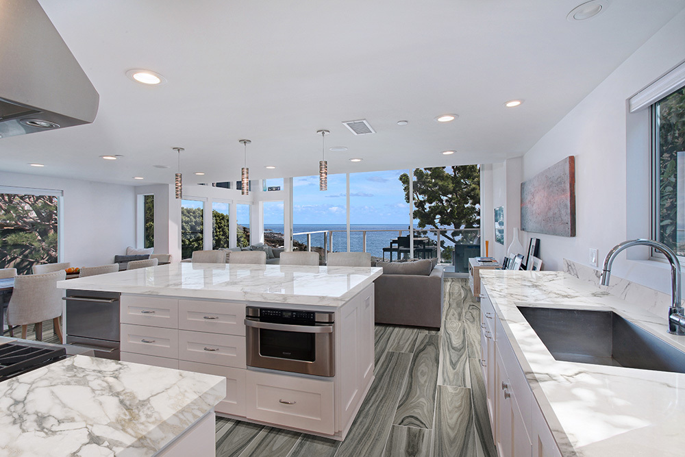 Open concept kitchen with waterfall island and porcelain slab counters demonstrating porcelain slab thickness for big kitchen surfaces.