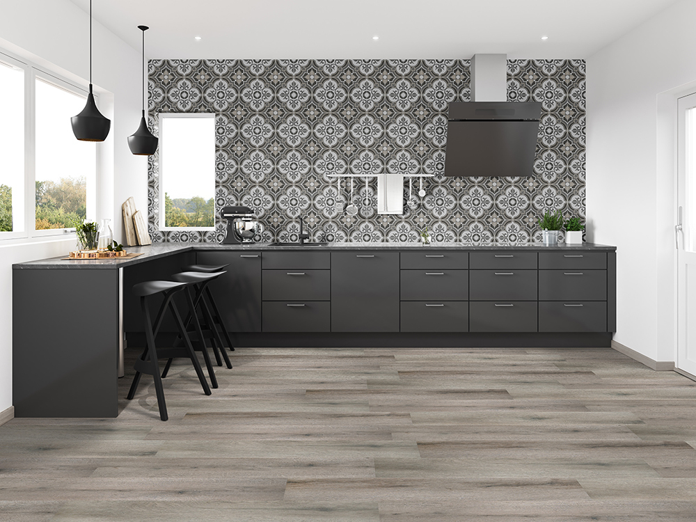 Modern kitchen with dark cabinetry and a beautiful tile backsplash with gray wood-look waterproof hybrid rigid core flooring.