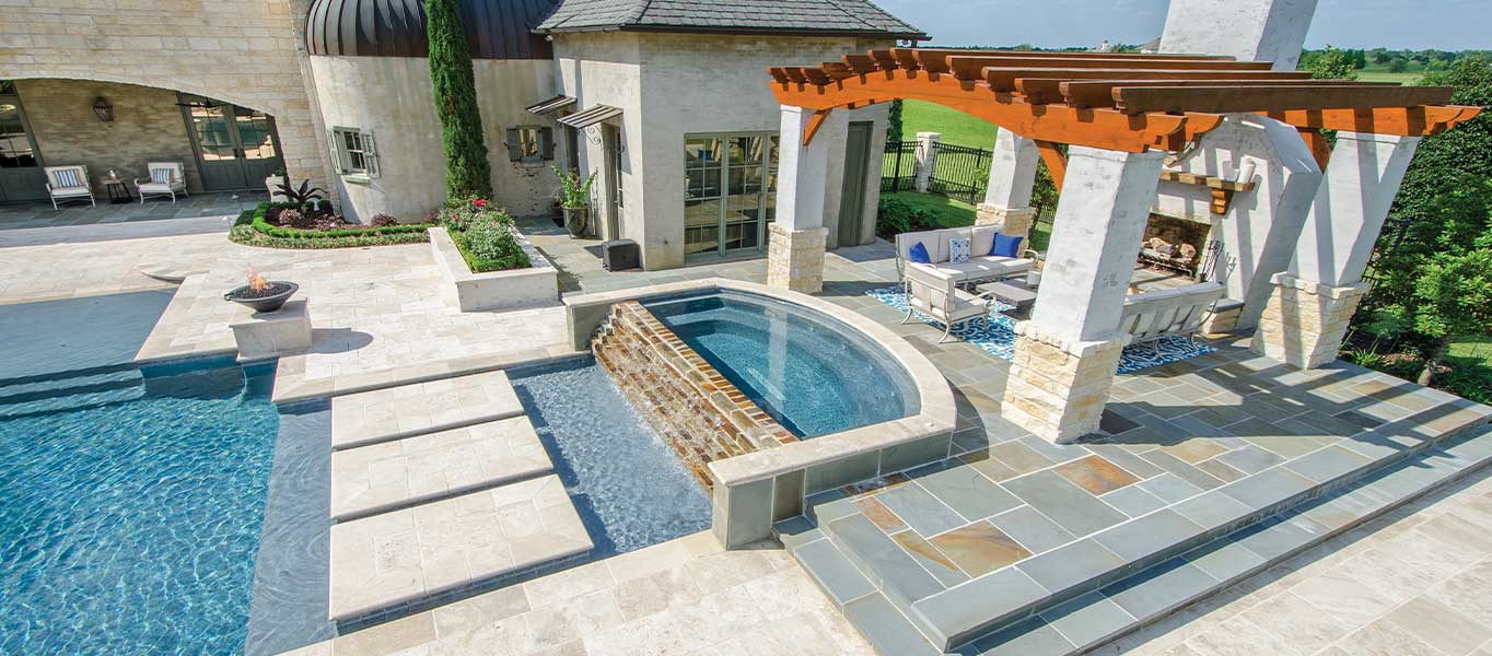 Outdoor pool with pavers, coping, and stacked stone
