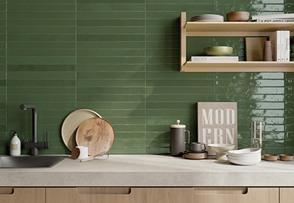 Kitchen backsplash with glossy green subway tile and open shelving styled with modern accessories