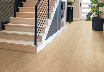 Entryway with light oak wood look porcelain tile flooring and staircase featuring black railings and modern decor