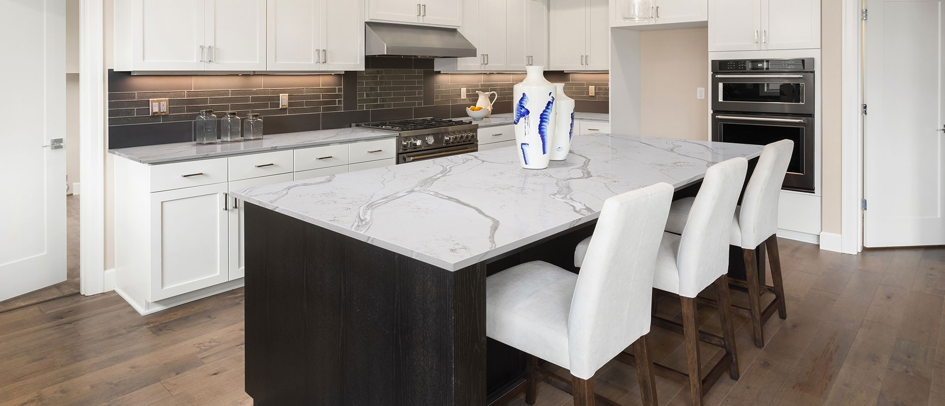 Calacatta Bolina quartz countertop in a minimalist kitchen with white cabinets