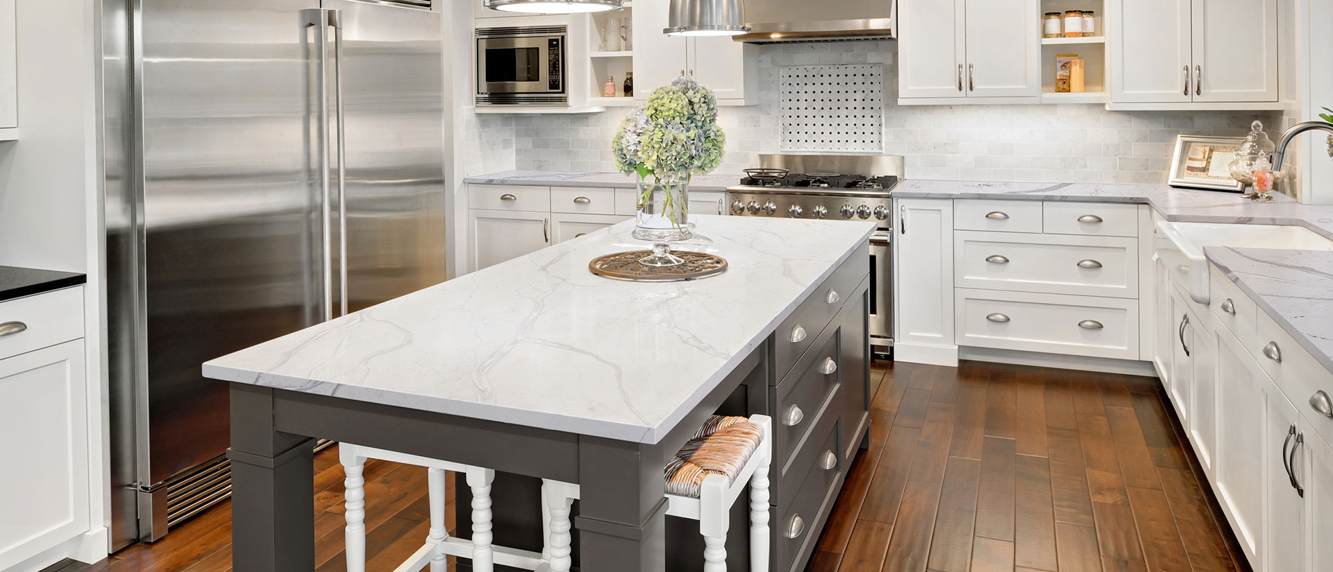 Calacatta Bolina quartz countertop in a spacious kitchen with wooden floors