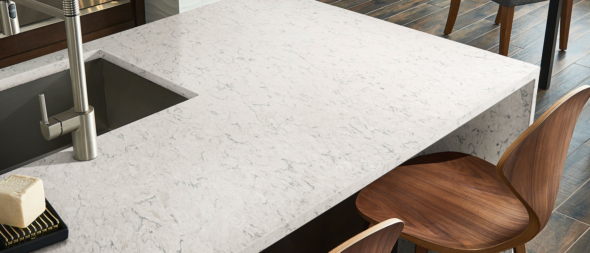 Carrara Mist Quartz countertop in a minimalist kitchen with wood accents