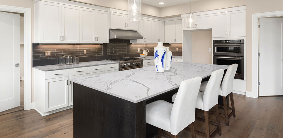Calacatta Bolina quartz countertop in a minimalist kitchen with white cabinets