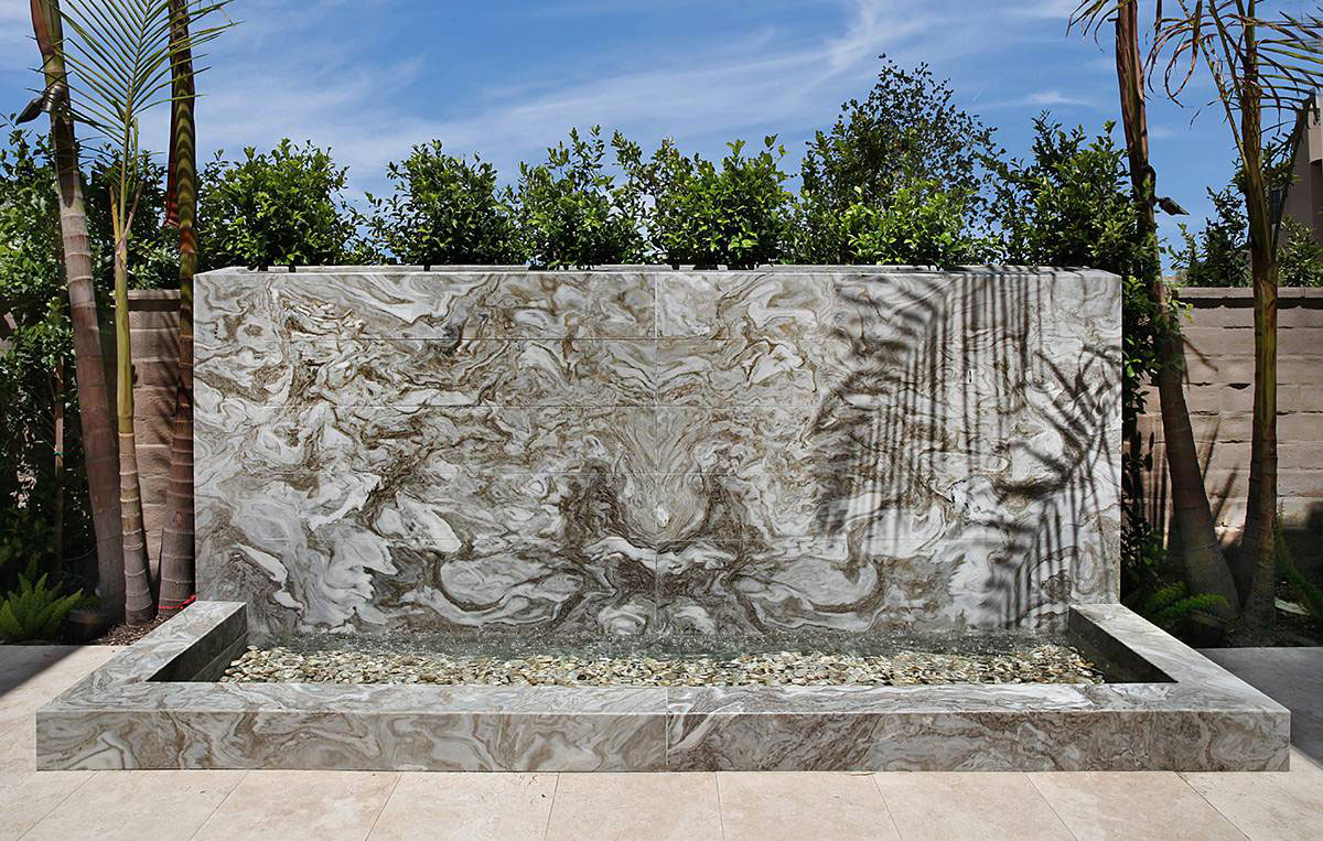 Avalanche White Marble Outdoor Water Feature with Tuscany Platinum Travertine pavers.