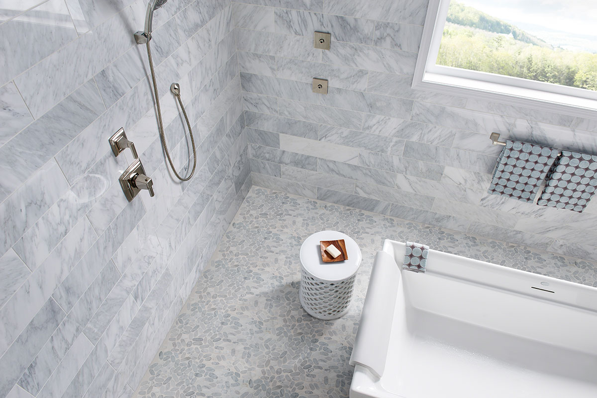 Sliced Carrara White Pebbles Mosaic wall in bathroom