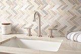 Angora Polished Herringbone Tile wall in bathroom