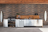 Brickstone Red 2X10 Brick Tile accent wall in outdoor kitchen